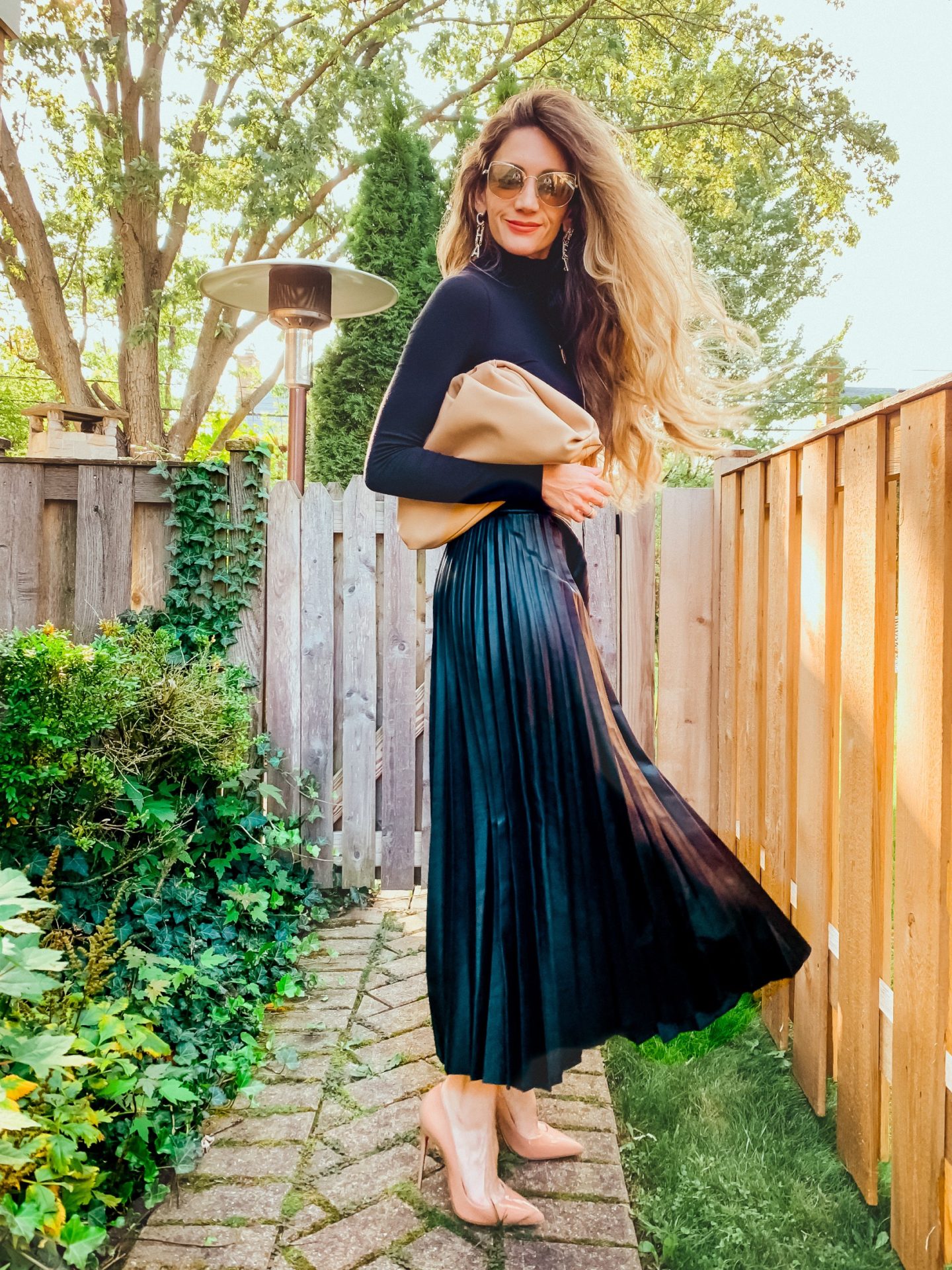 This fall fashion staple is easy to style and really versatile for work, elevating a look while being comfortable or date night. Here's 5 ways to style a pleated leather skirt.